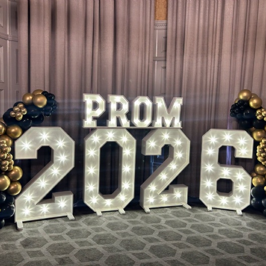 balloons and banner saying prom 2026